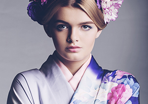 Young woman in purple kimono and flower headress