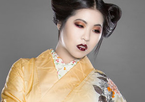 Young woman in yellow floral traditional kimono