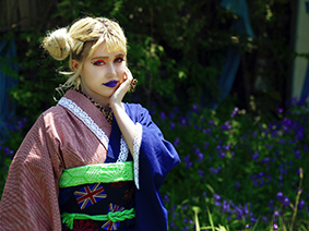 Young woman in kimono next to purple flowers in Tokyo